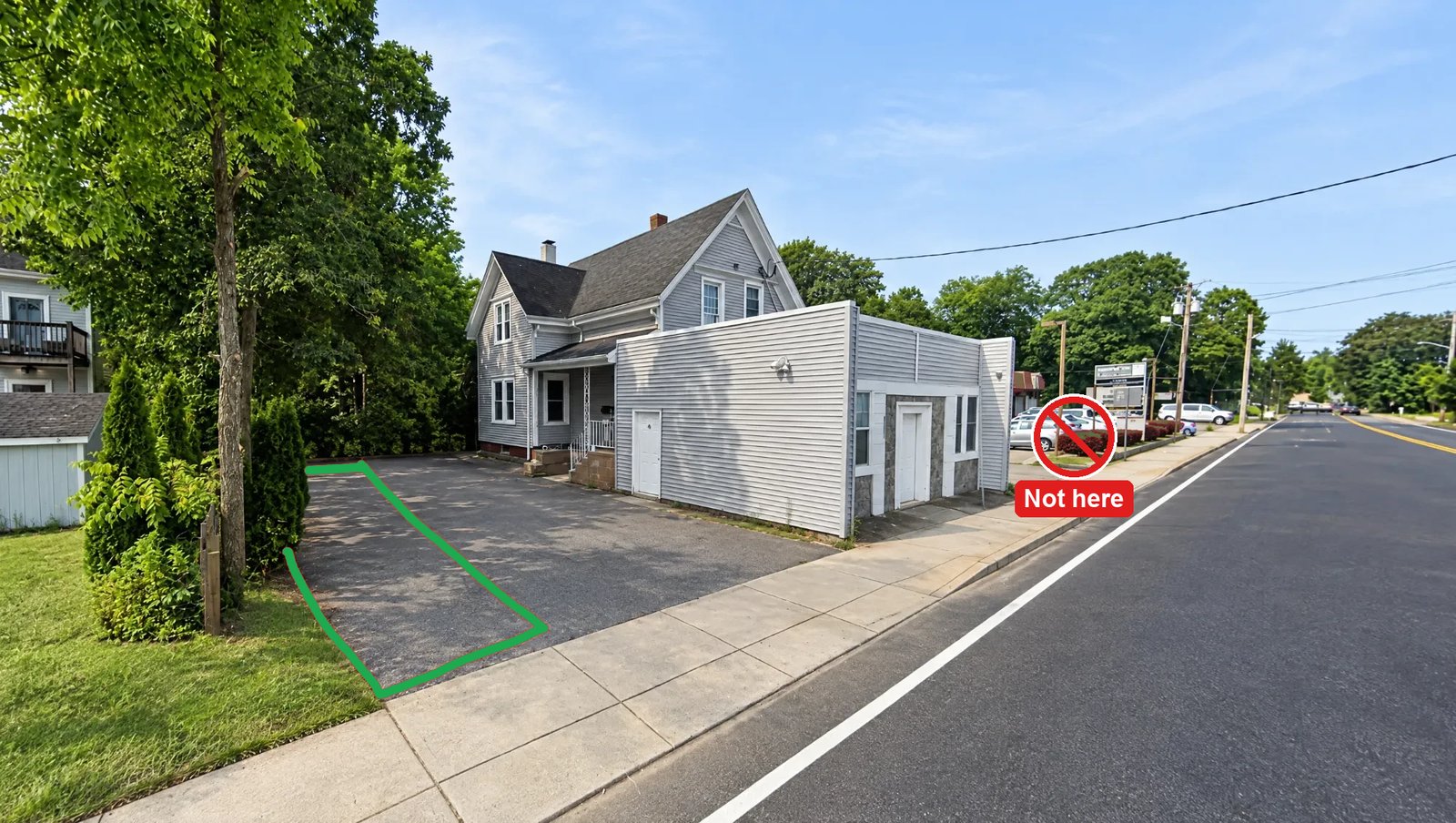 Mag Luxe Studios from Pleasant St. The green outline on the left side of the driveway, along the trees, is where to park. The lot next door is marked Not here.