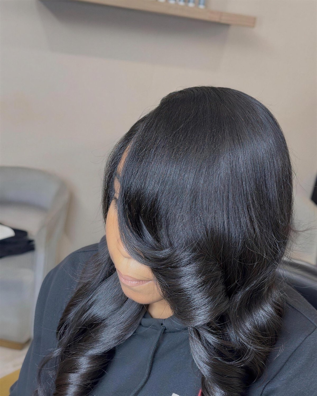 Long sew-in with big soft curls and a side part.